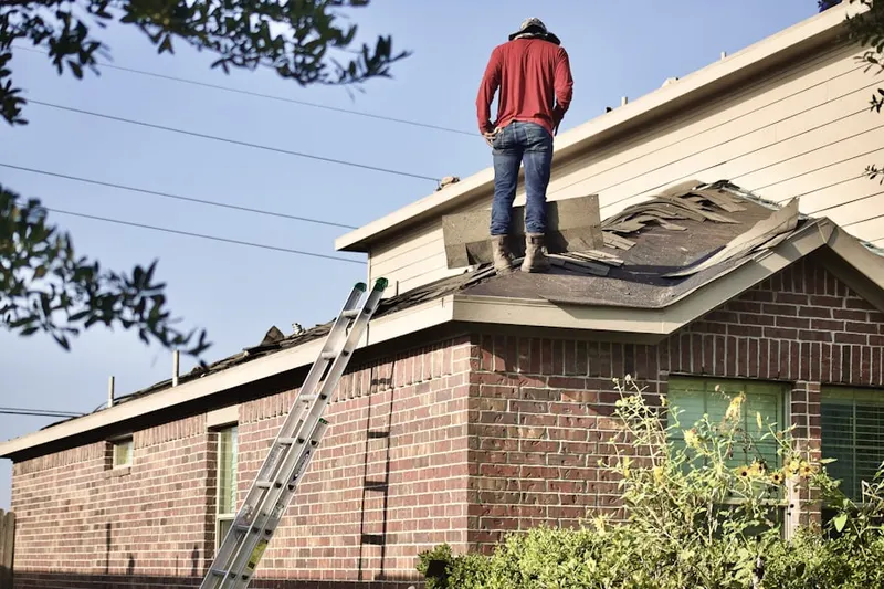 Professional roofer working on a residential roof in Olde Orchard